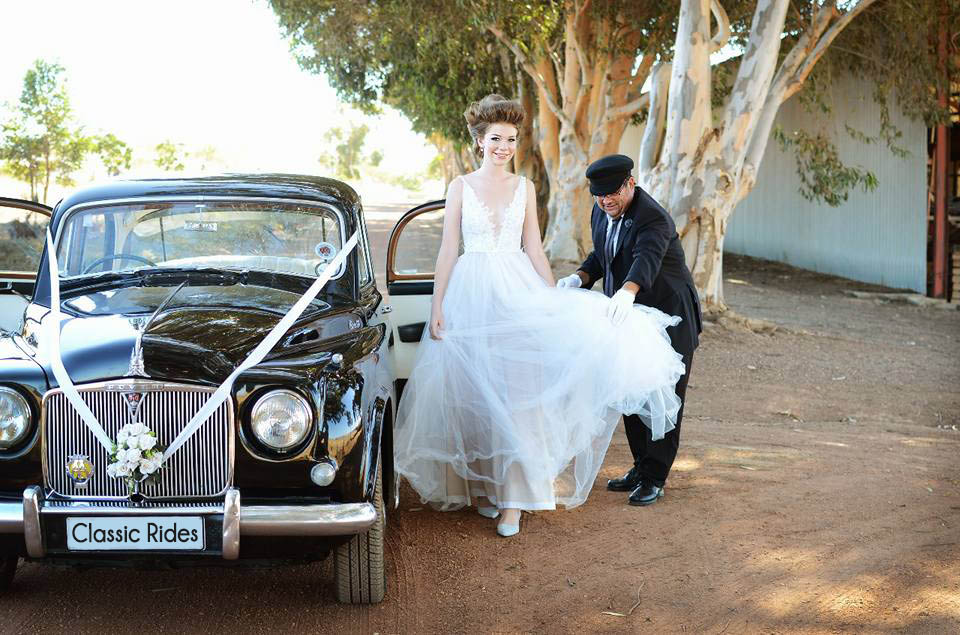 Happy owner helping bride out car